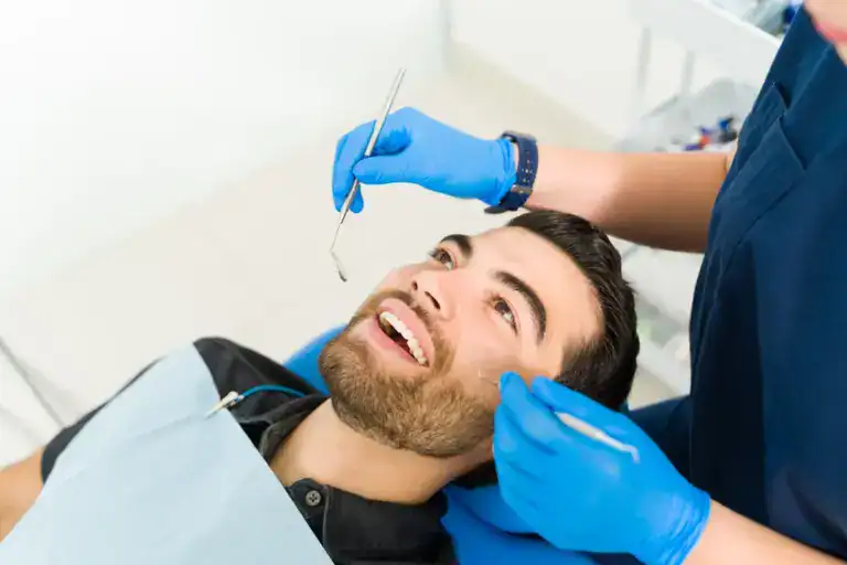 A smiling man receiving dental treatment