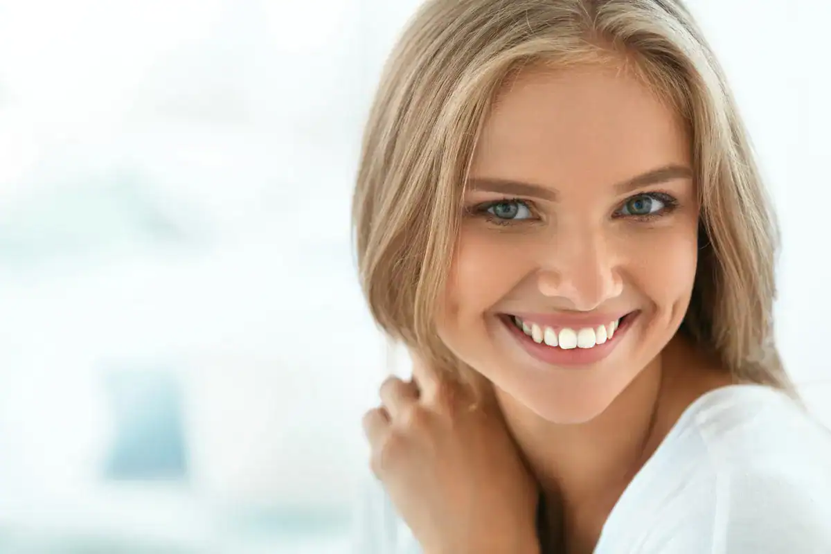 A smiling woman with clear teeth, close-up portrait for dental care.